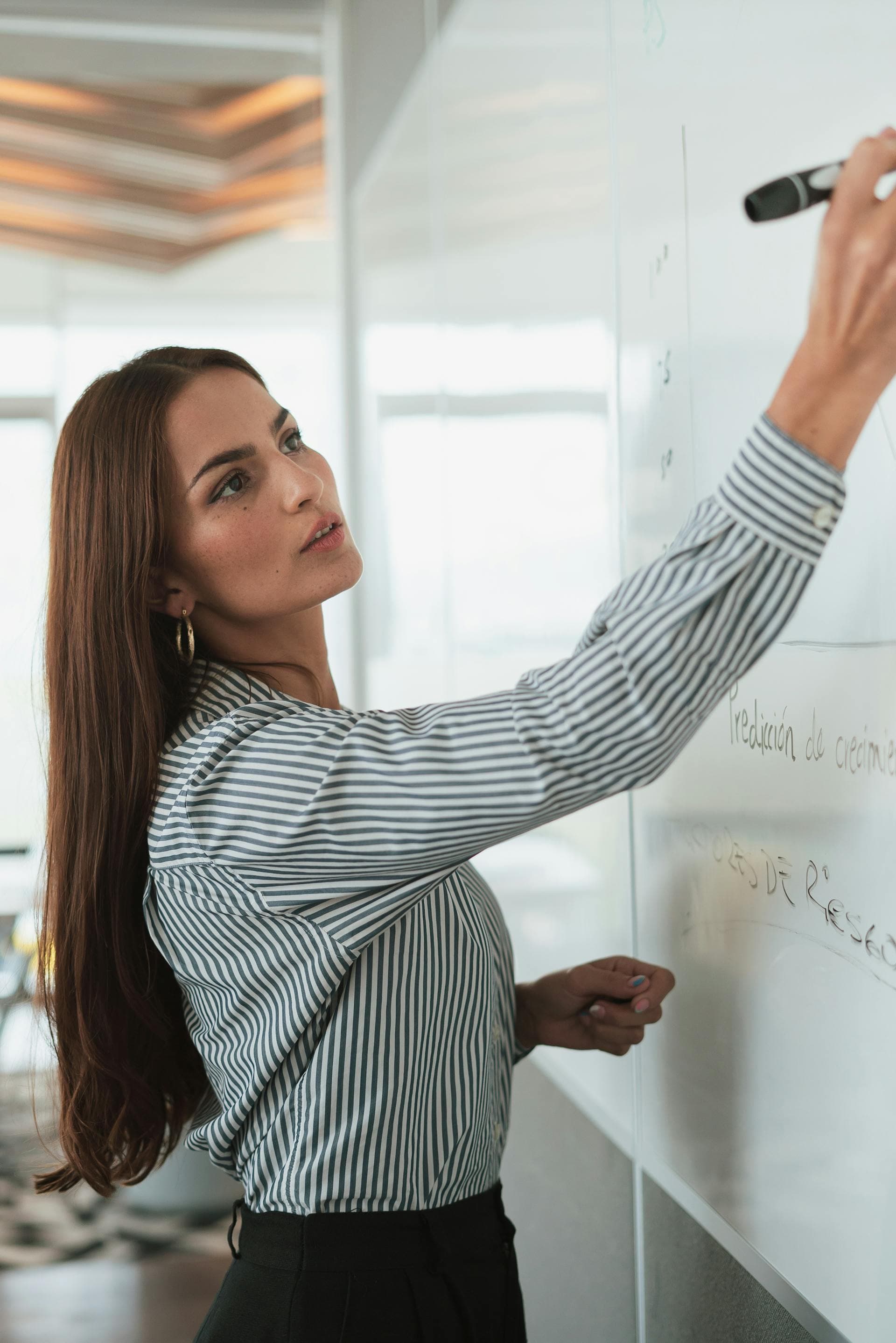 woman drawing on whiteboard